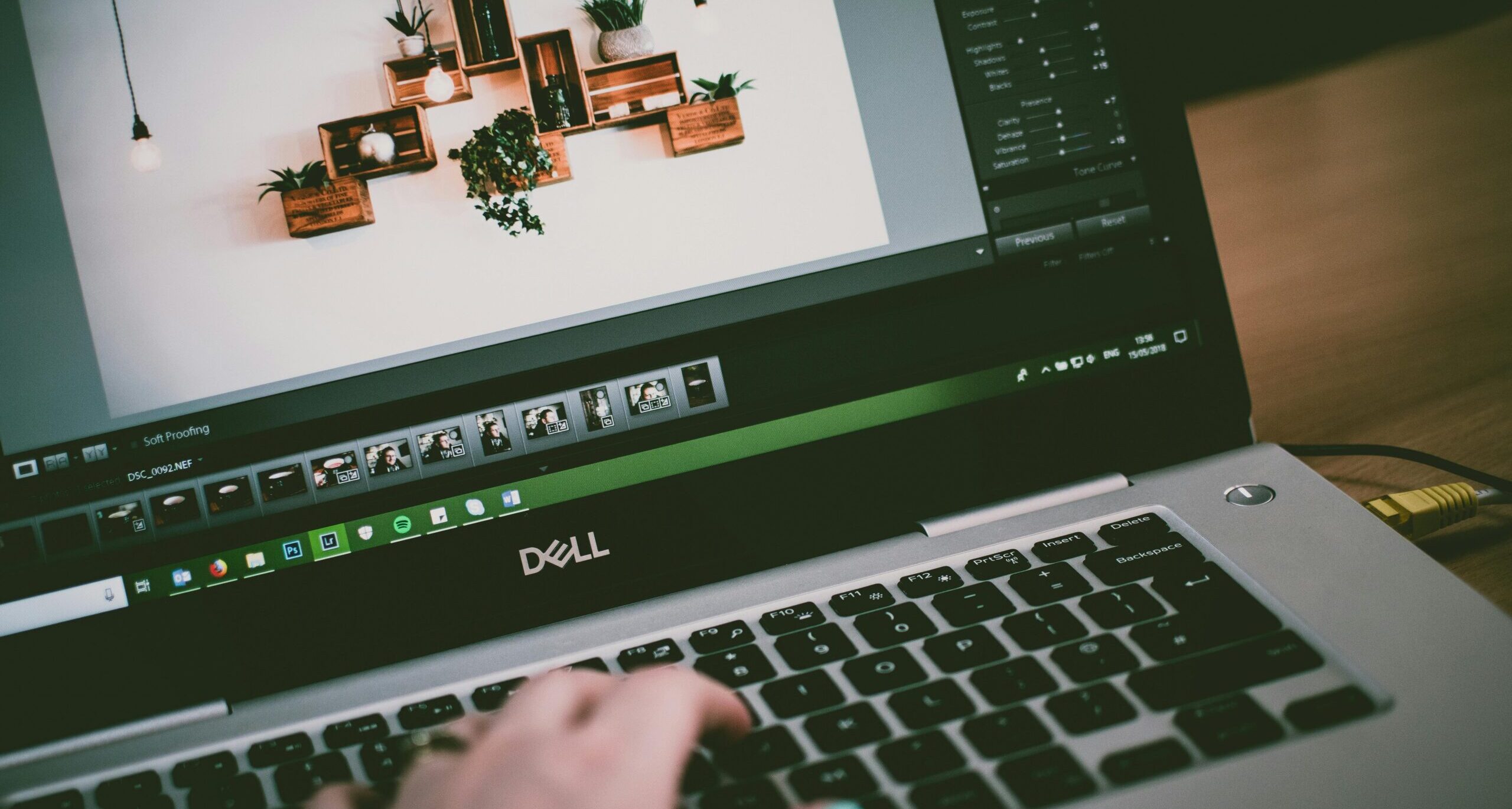 A person going through pictures in a Dell laptop