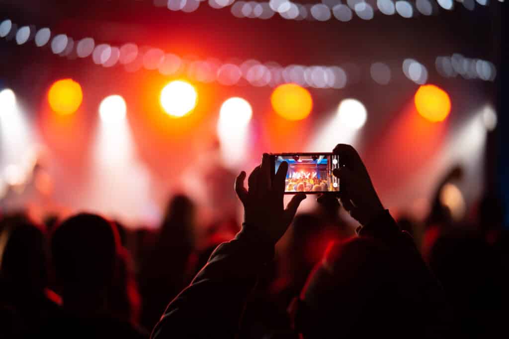 A person with a phone during a Lolla concert