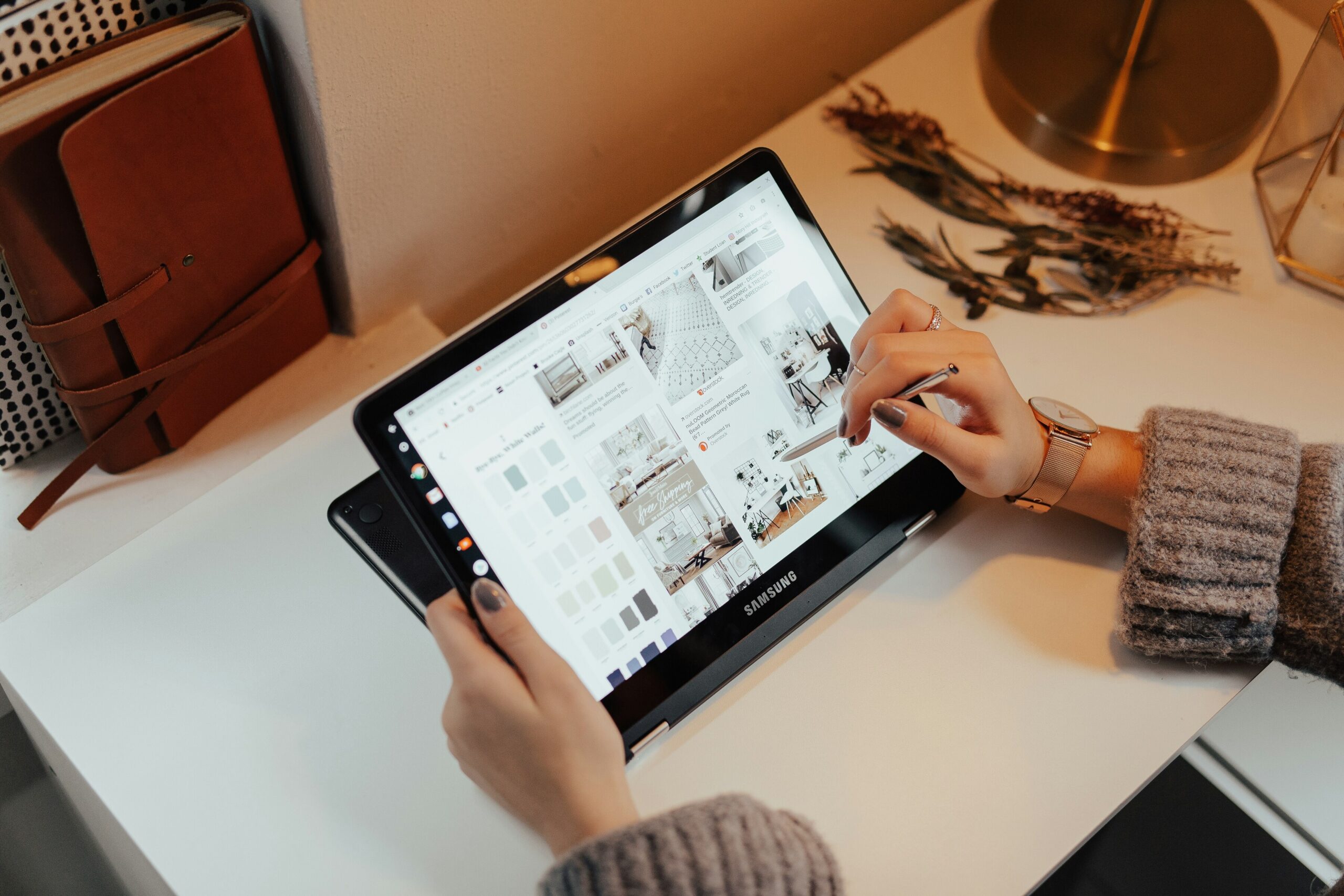 woman holding black samsung tablet computer